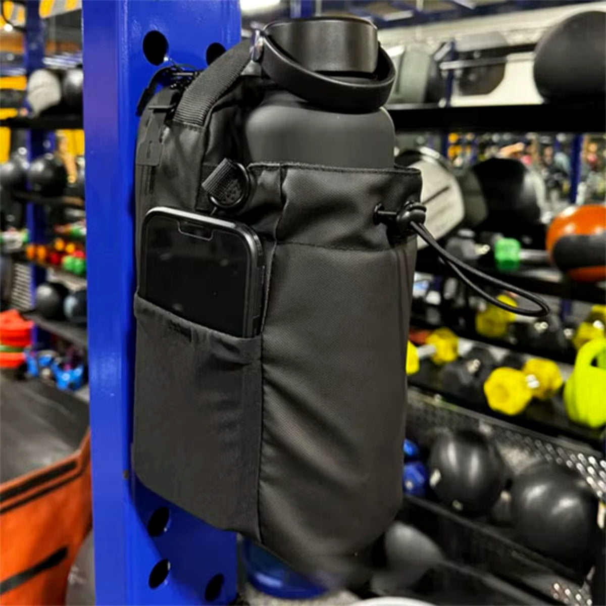 Magnetic gym bag holding phone and bottle